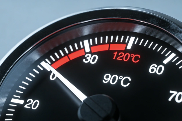 engine overheating warning light on car dashboard indicating high engine temperature